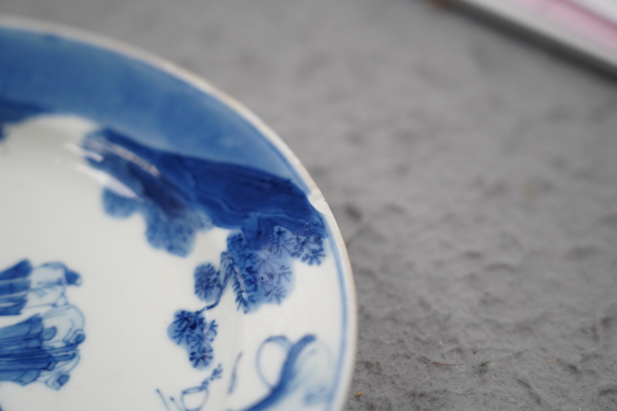 A pair of Chinese blue and white small plates, Kangxi period, hairline cracks to one plate.